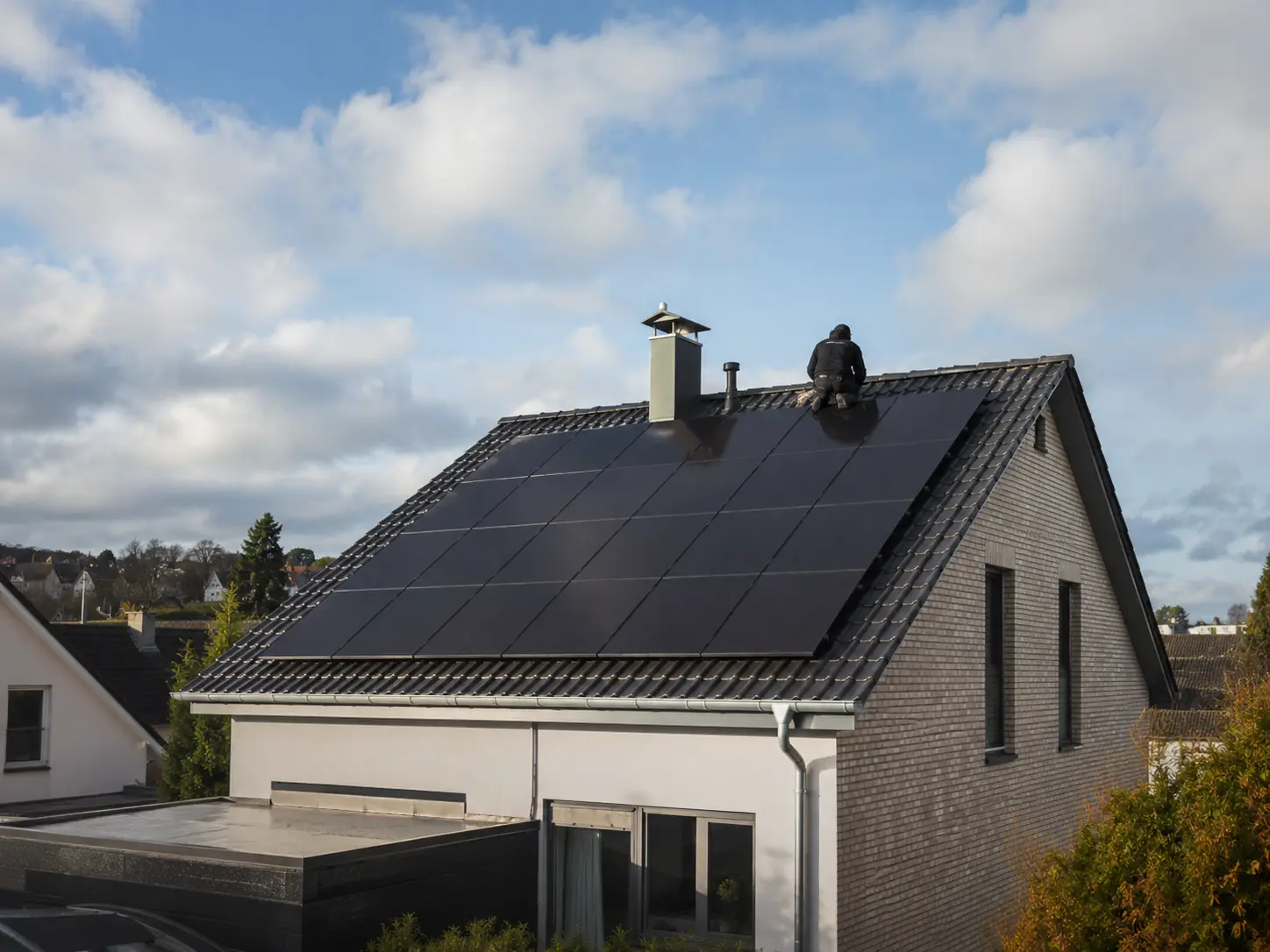 Technician installing a rooftop photovoltaic system